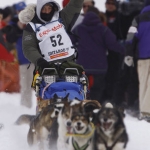 Kim Darst and Dog Team  Waving while Racing